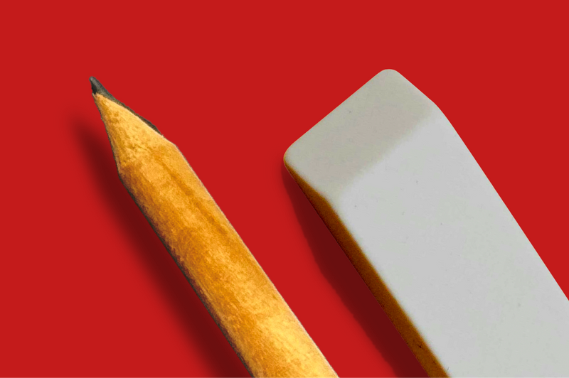 A pencil and eraser on a red background