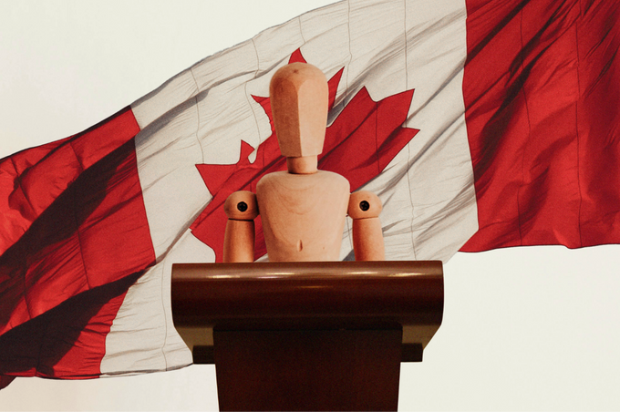 A marionette stands at a podium. with the Canadian flag as a backdrop